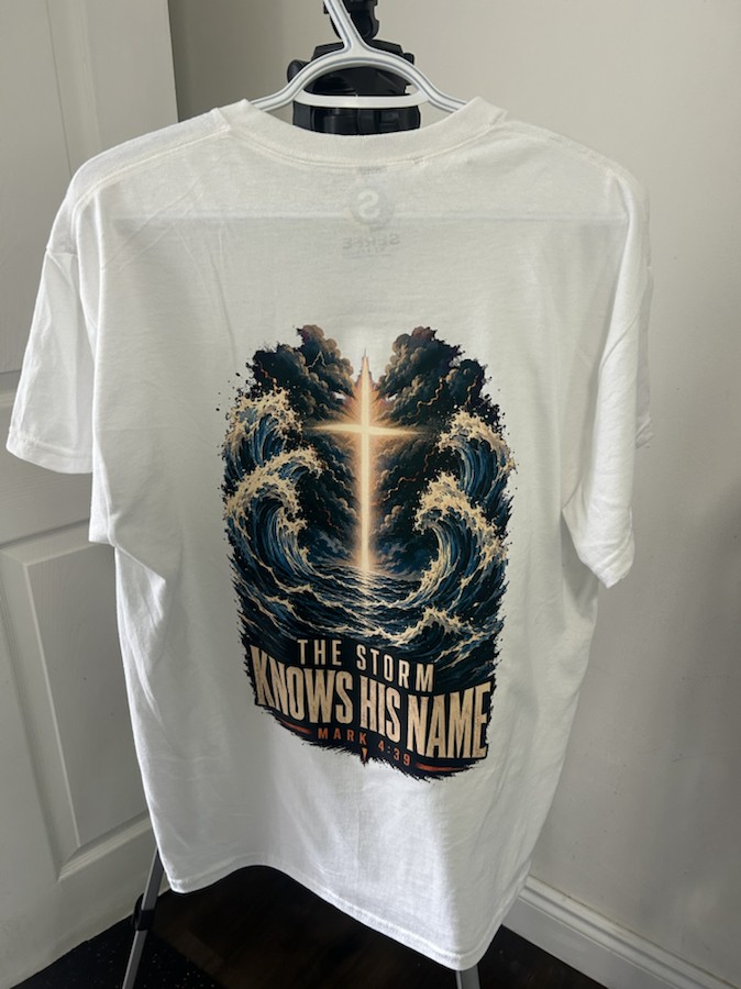 A finished white Serfe Studio T-shirt with the design The storm knows his name